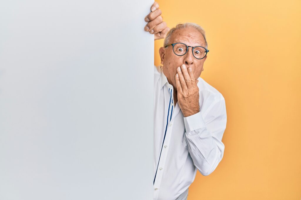 old man behind a wall