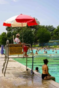 Lifeguard at lifeguard stand at pool
