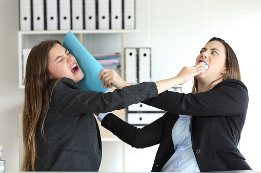 Two women shoving each other