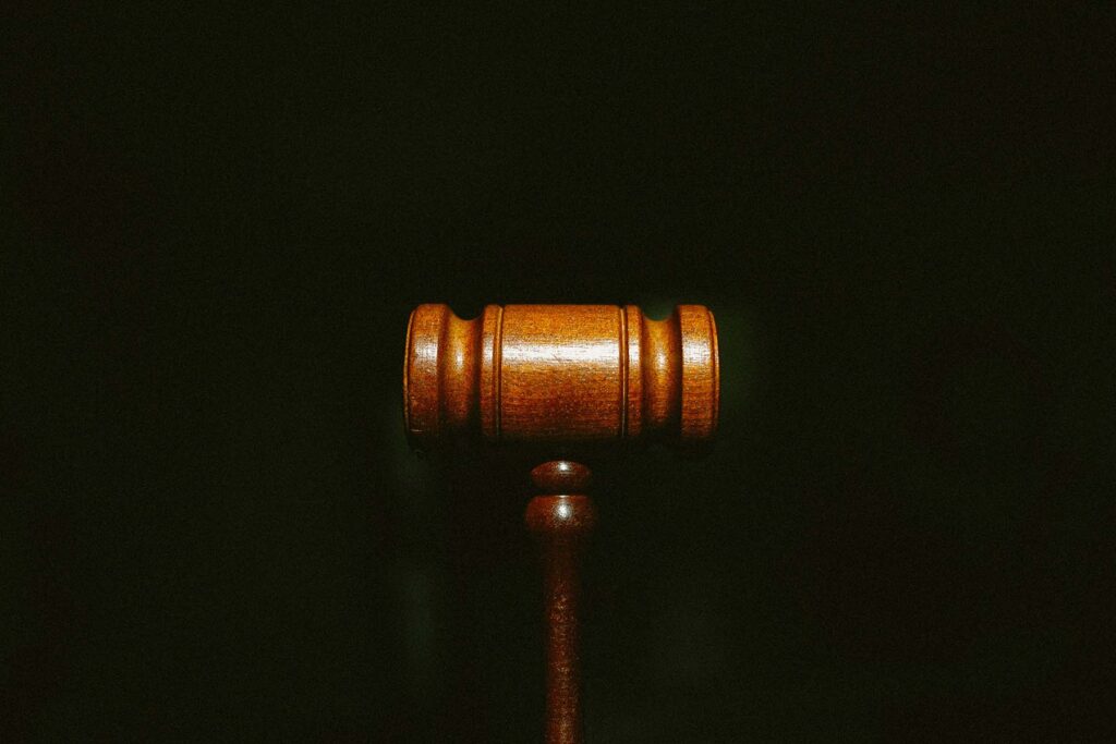 A judges mallet on a black backdrop