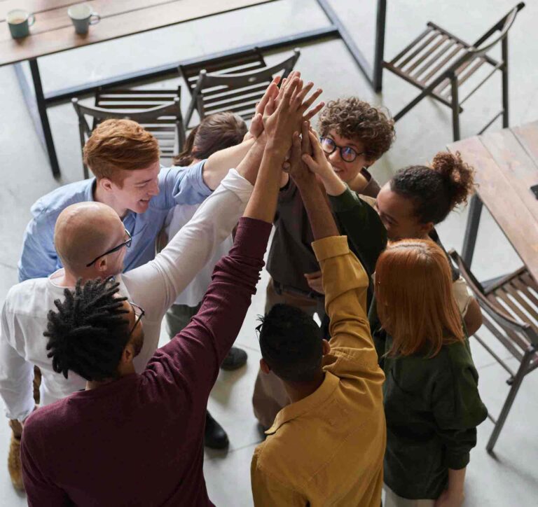 Group of people all high fiving in the center